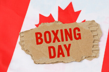 Against the background of the flag of Canada lies cardboard with the inscription - Boxing Day