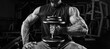 © andy_gin - Muscular man sits on a bench with a dumbbell in the gym. Fitness and bodybuilding concept.