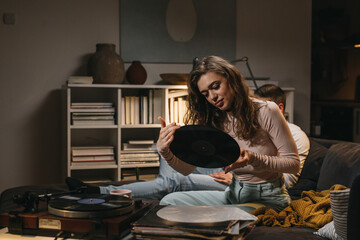 Wall Mural - couple listening records at home. evening scene