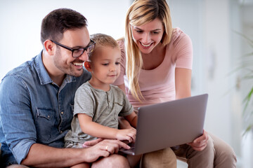 Canvas Print - Happy family watching something on laptop