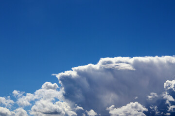 Airy white clouds in a blue sky