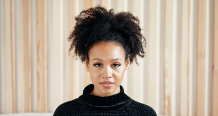 Wall Mural - Portrait of a woman of African American appearance. A smart student gets an education through video communication, looks at the monitor.