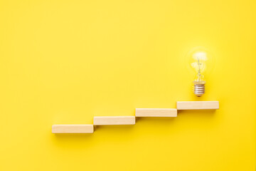 abstract business strategy concept. steps to idea symbol shown as light bulb over yellow background. inspiration and innovation conceptual