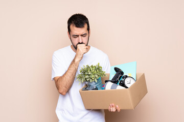 Wall Mural - Man holding a box and moving in new home over isolated background is suffering with cough and feeling bad