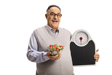 Canvas Print - Happy mature man holding a healthy fresh salad in a bowl and a measuring scale