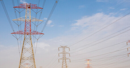 high voltage electric towers during sunset.