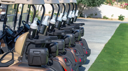 Wall Mural - A row of electric golf carts on a golf course.