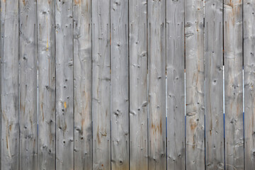  Natural background from a simple fence made of old rough wooden planks with the texture of unsmiled wood.