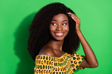 Poster - Photo of young sweet charming smiling positive african girl with perfect silky hair isolated on green color background