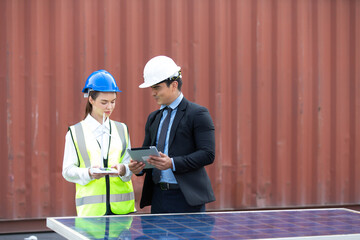 Technical expert in solar photovoltaic panels holding light bulb in hand and discussion with engineer woman in new project