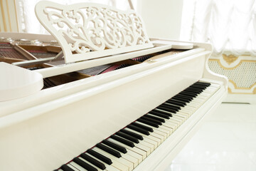 white grand piano with keys close-up. classical music