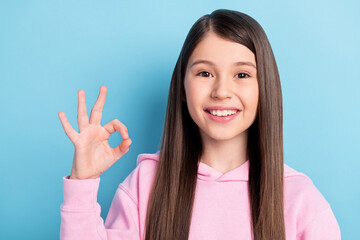 Poster - Close-up portrait of attractive cheerful girl showing ok-sign ad perfect isolated over bright blue color background