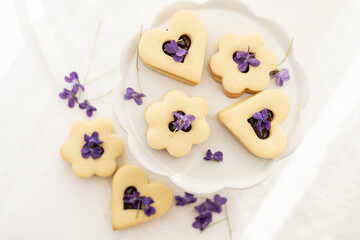 Wall Mural - selection of sweet baked cream edible flowers and fruit dessert cakes for mothersday, wedding, birthday, paerty celebration. viola odorata cake. 