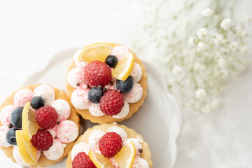 Wall Mural - selection of sweet baked cream edible flowers and fruit dessert cakes for mothersday, wedding, birthday, paerty celebration. viola odorata cake. 