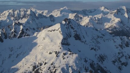 Wall Mural - 4k aerial dramatic mountains winter sunset