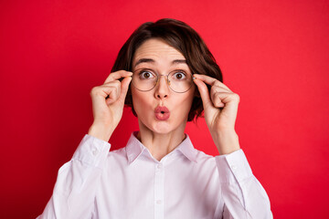 Wall Mural - Photo portrait of amazed business woman wearing glasses white shirt staring isolated vivid red color background