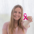 © Bangkok Click Studio - Woman holding pink ribbon the symbol of breast cancer and smile for supported the cancer patient