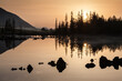 Sunrise at lake in mountain range. Beautiful reflection in water