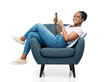 © Syda Productions - comfort, people and furniture concept - portrait of happy smiling young african american woman with smartphone sitting in modern armchair over white background