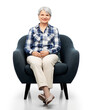 comfort, furniture and old people concept - smiling senior woman sitting in modern armchair over white background