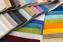 Samples Of Fabrics For Upholstery, Roman Blinds. Multicolored Fabric Swatches Spread Out In A Circle.