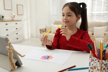 Poster - Little girl drawing on paper with marker at online lesson indoors. Distance learning