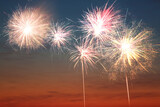 Fototapeta Sypialnia - Beautiful bright fireworks lighting up twilight sky outdoors