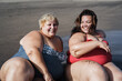 © DisobeyArt - Plus size women sitting on the beach having fun during summer vacation - Focus on right girl face