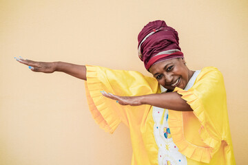 Wall Mural - Senior african woman dancing outdoor - Focus on face