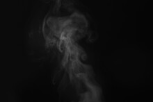 White Steam In Air Against Black Background