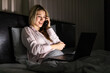 © F8  \ Suport Ukraine - Young pretty woman indoors at home in bed using laptop computer talking by mobile phone.