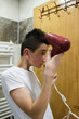 © Minet - Boy dries hair the hair dryer.