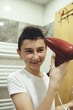 © Minet - Boy dries hair the hair dryer.