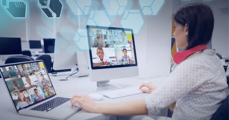 Wall Mural - Composition of science icons over teacher and school children on computer and laptop online lesson