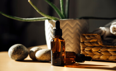 Glass bottle with cosmetic essential oil and organic natural product. 