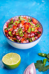 Wall Mural - Homemade salsa pico de gallo, mexican cuisine, blue background