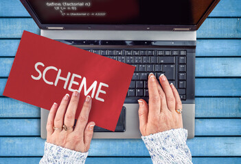 scheme programming language. word scheme on paper and laptop