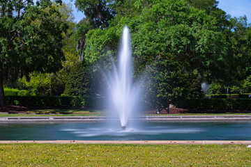 fountain in the park; long exposure creates a silky effect of spouting water.