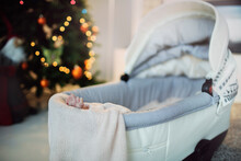 Baby Newborn Baby Sleeping In The Stroller In The Room With Christmas Tree