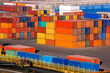 container terminal port warehouse with export cargo stockpiled and transported by truck with trailer stacks of multi-colored iron containers brokerage services, nobody.