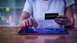 © ArLawKa - Young woman holding a credit card and using a tablet to shop online, e-commerce, internet banking, spend money, work from home)) credit card