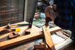 © somchai20162516 - Carpenter drills a hole with an electrical drill Carpenter doing his job in carpentry workshop.
