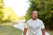 © digitalskillet1 - Mature African American man taking a walk outside.