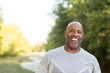 © digitalskillet1 - Mature African American man taking a walk outside.
