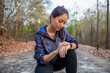 © tuiphotoengineer - Asian women are pressing start the sport watch or smart watch for jogging.