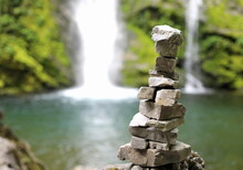 Pile Made Of Stones Called The Orientation Man To Indicate The Right Direction In The Mountains Is A Small Pond With A Waterfall