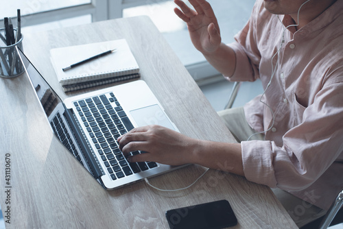 Casual business man making video call, using zoom online meeting app via laptop computer, work from home