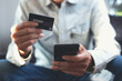 © tippapatt - Man using mobile phone and credit card for online shopping and internet payment via digital mobile banking app.