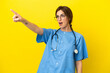 © luismolinero - Surgeon doctor woman isolated on yellow background pointing away