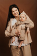© Ananass - portrait of a cute baby and her mom holding a baby in her mother's arms